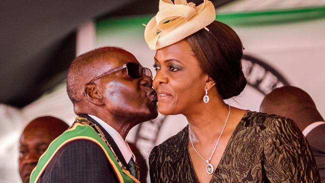 Mugabe kisses his wife and first lady Grace Mugabe during during the country's 37th Independence Day celebrations at the National Sports Stadium in Harare in 2017.