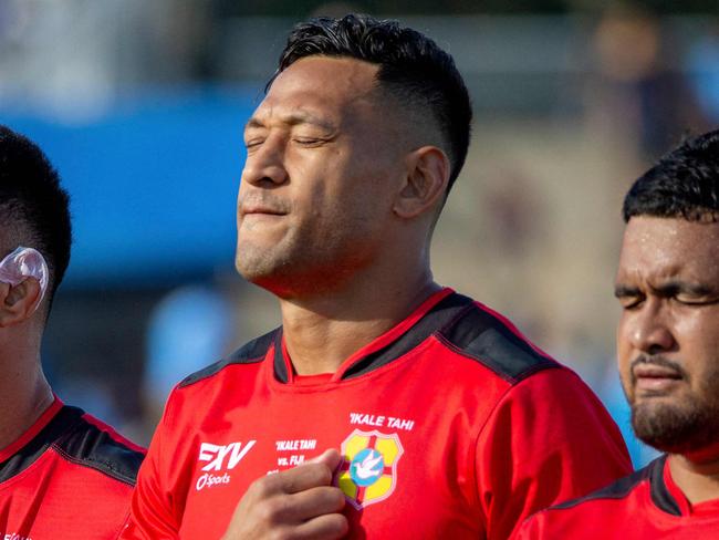 Former Australian rugby player Israel Folau (2nd R) with Tongan teammates sing national anthem prior to the World Rugby Pacific Nations Cup match between Fiji and Tonga at HFC Stadium in Fiji's capital city Suva on July 2, 2022. (Photo by Leon LORD / AFP)