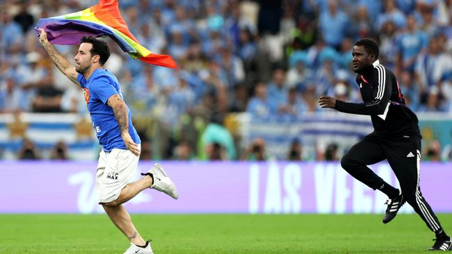 A pitch invader wearing a shirt reading "Save Ukraine"