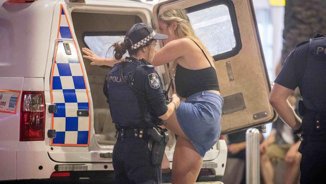 Victorian Schoolies flock to Surfers Paradise to celebrate high school graduation. A woman is taken into police custody. Picture: Jake Nowakowski