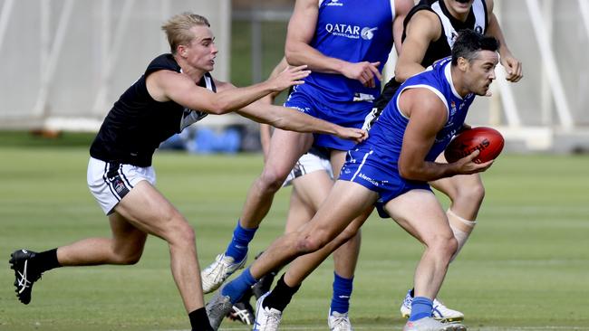 SPOC star Jesse O’Brien evades a tackler in his side’s win over Adelaide University on Saturday. Picture: Naomi Jellicoe