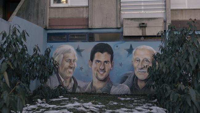 A mural depicting Novak Djokovic, his first coach Jelena Gencic (left) and his grandfather Vladimir Djokovic in Belgrade, Serbia. Picture: Getty Images.