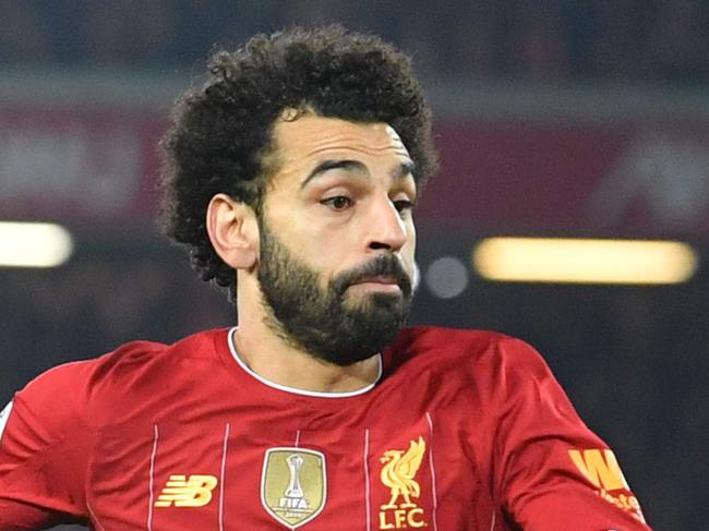 Liverpool's Egyptian midfielder Mohamed Salah (L) runs on to a through ball during the English Premier League football match between Liverpool and Wolverhampton Wanderers at Anfield in Liverpool, north west England, on December 29, 2019. (Photo by Paul ELLIS / AFP) / RESTRICTED TO EDITORIAL USE. No use with unauthorized audio, video, data, fixture lists, club/league logos or 'live' services. Online in-match use limited to 120 images. An additional 40 images may be used in extra time. No video emulation. Social media in-match use limited to 120 images. An additional 40 images may be used in extra time. No use in betting publications, games or single club/league/player publications. /