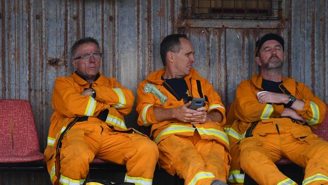 A team of fire fighters take a well-earned break Kingscote Oval after fighting fires through the night, on Kangaroo Island. Friday, January 10, 2020. Photo: David Mariuz / AAP.