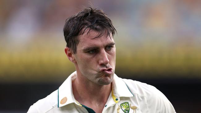 TOPSHOT - Australia's captain Pat Cummins reacts as he walks off the ground after being dismissed on day two of the third cricket Test match between Australia and India at The Gabba in Brisbane on December 15, 2024. (Photo by DAVID GRAY / AFP) / -- IMAGE RESTRICTED TO EDITORIAL USE - STRICTLY NO COMMERCIAL USE --