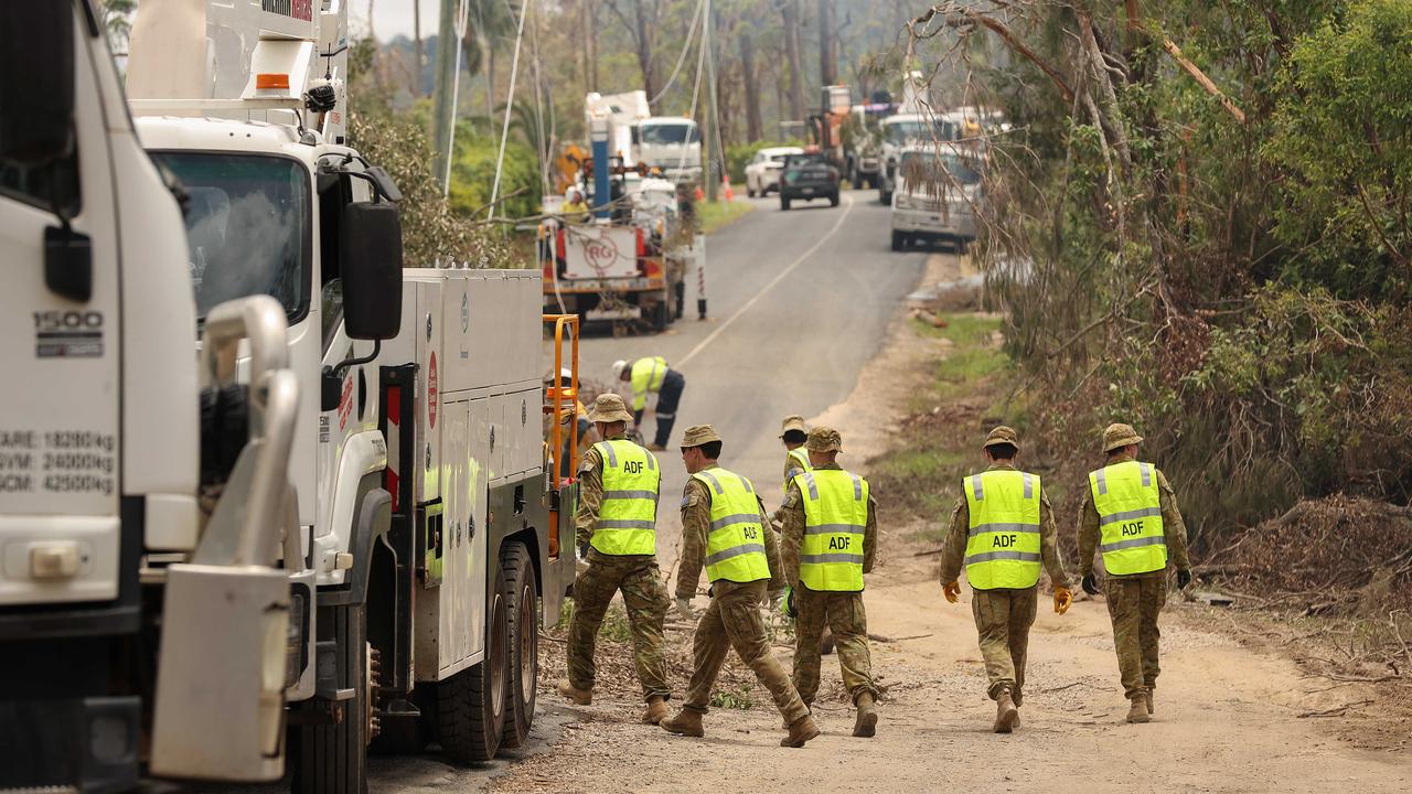 ADF troops help in the clean up at Kriedman Road in Wangawallan. Pics Adam Head