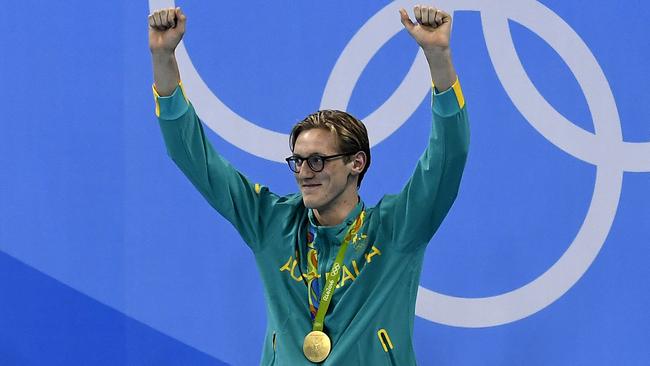 Australia's Mack Horton celebrates on the podium with his gold medal.