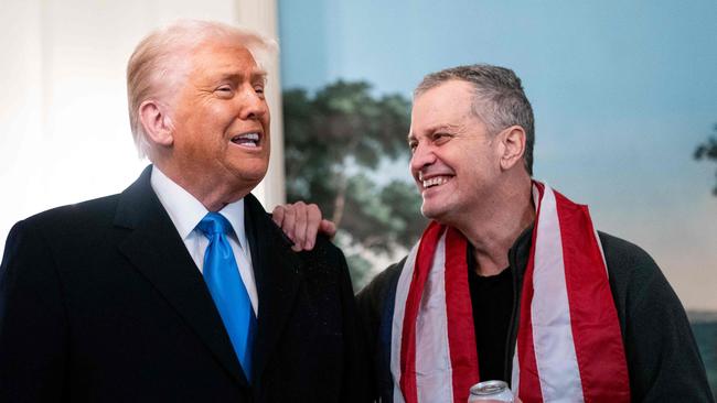 TOPSHOT - US President Donald Trump (L) welcomes former detainee Marc Fogel to the White House after he was freed from Russia in Washington, DC, on February 11, 2025. Fogel, a US teacher detained in Russia since 2021 on drugs charges, was released February 11 after an "exchange" with Moscow, the White House. Trump said he hoped Fogel's release could mark the start of fresh ties with Moscow to end the Ukraine war. (Photo by Allison ROBBERT / AFP)