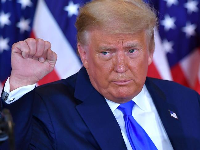 (FILES) In this file photo US President Donald Trump pumps his fist after speaking during election night in the East Room of the White House in Washington, DC, early on November 4, 2020. - US President Donald Trump hailed the "great news" on November 9, 2020 that a vaccine jointly developed by Pfizer and BioNTech was 90 percent effective in preventing Covid-19 infections. "STOCK MARKET UP BIG, VACCINE COMING SOON. REPORT 90% EFFECTIVE. SUCH GREAT NEWS!" the President tweeted minutes after Pfizer announced the development and days after he lost the US presidential election to Democrat Joe Biden. (Photo by MANDEL NGAN / AFP)