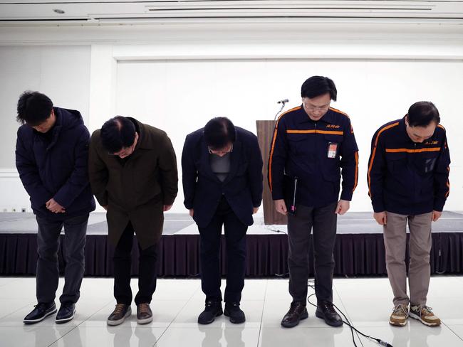 Jeju Air CEO Kim E-bae and other executive members bow in apology ahead of a briefing in Seoul after the crash. Picture: AFP