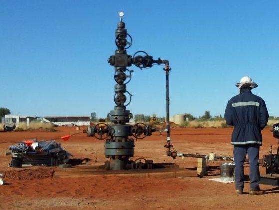 Central Petroleum Surprise well head oil well 400km west of Alice Springs. Here workers are installing the production line which leads to the storage tanks. Picture supplied, taken in mid-June 2012.