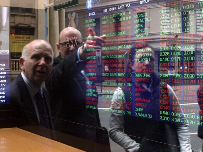 Investors look at stocks on electronic stock boards at the Australia Securities and Exchange (ASX) headquarters in Sydney, Australia, on Tuesday, Sept. 9, 2011. Photographer: Sergio Dionisio/Bloomberg