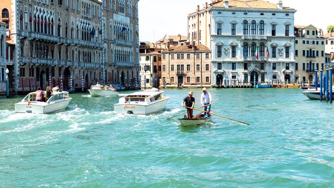 A traditional two-person row boat in Venice's Grand Canal.