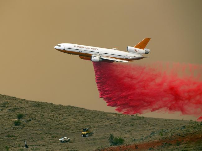 An RFS aerial bomber drops fire repellent near the village of Bredbo. Picture: Gary Ramage