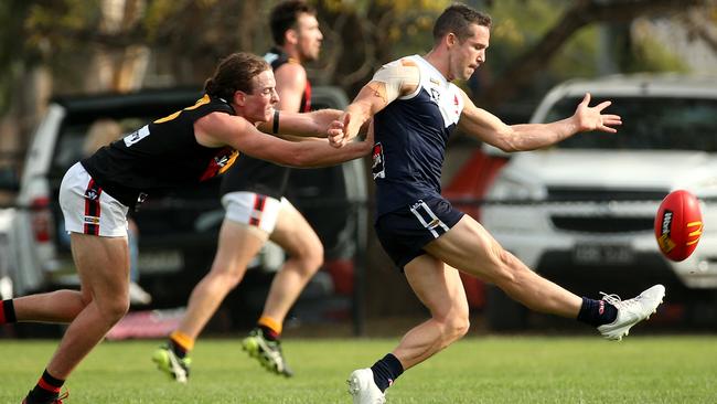 Matthew Sullivan kicks clear of Nicholas Stuhldreier. Picture: Hamish Blair