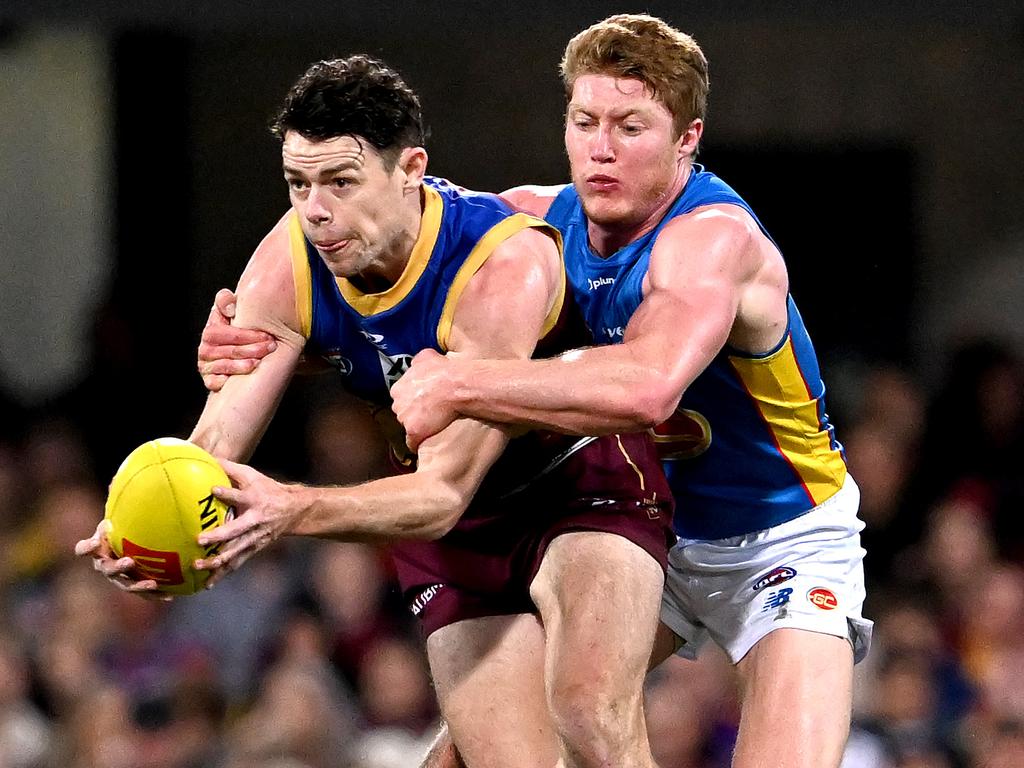 BRISBANE, AUSTRALIA - JULY 23: Lachie Neale of the Lions  attempts to break away from the defence of Matt Rowell of the Suns during the round 19 AFL match between the Brisbane Lions and the Gold Coast Suns at The Gabba on July 23, 2022 in Brisbane, Australia. (Photo by Bradley Kanaris/Getty Images via AFL Photos)