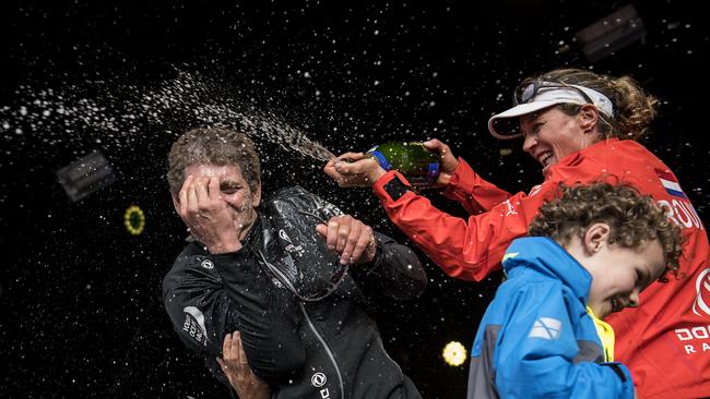 Carolijn Brouwer, with son Kyle, spraying champagne on French skipper Charles Caudrelier after winning the Volvo Ocean Race.