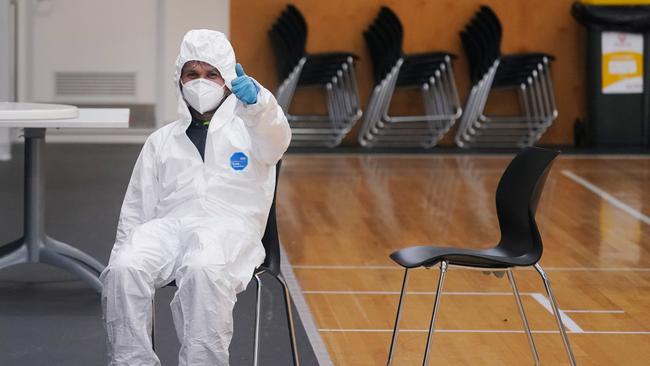 Cleaners are seen working at The Hangar in Melbourne on Sunday. Picture: AAP