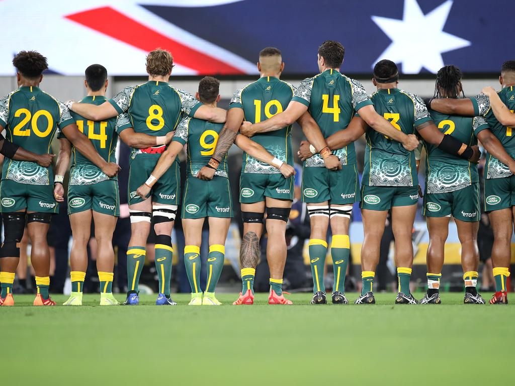 Australian players stand for the national anthem.