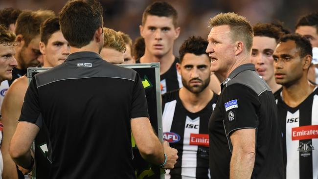 Collingwood coach Nathan Buckley talks to his players at three-quarter time.