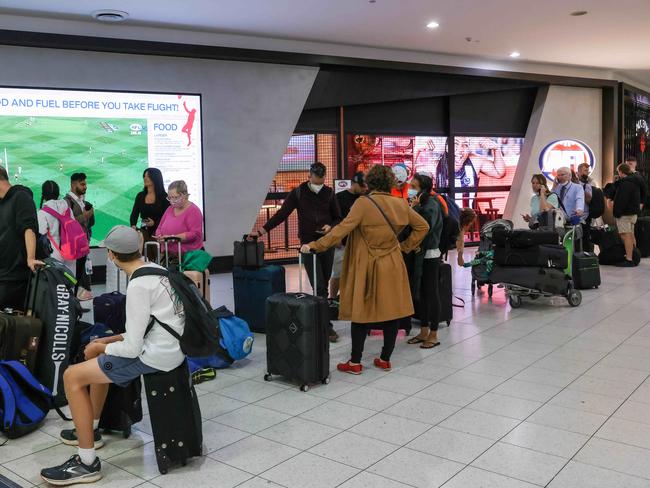 Qantas managers loading aircraft amid holiday chaos