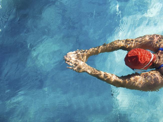 Athletic swimmer is diving in a swimming pool - generic Prime Time