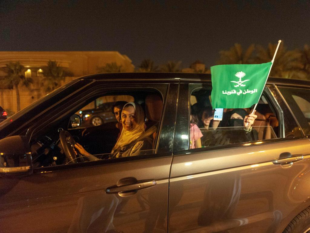 A Saudi woman and her friends celebrate her first time driving on a main street of Khobar City.