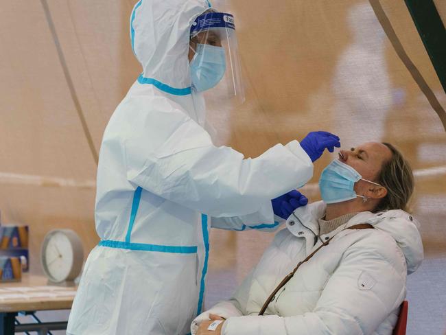 A healthcare worker takes a swab sample. Picture: AFP