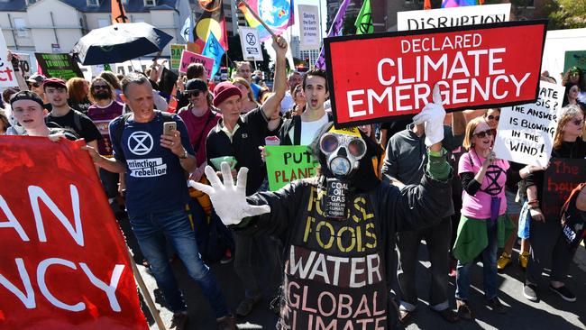 Extinction Rebellion protesters are seen blocking streets in the Brisbane CBD today. Picture: AAP