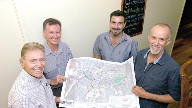 Golf course designer Graham Marsh, left, company director Jonathan Mann, project manager Jason Sullivan and company director Michael Mann with plans for the Station Creek Lifestyle Resort. Picture: Jon Ortlieb