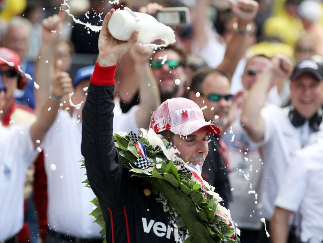 Will Power celebrates his Indy 500 win by drinking milk. Well, kinda. Picture: Chris Graythen/Getty Images