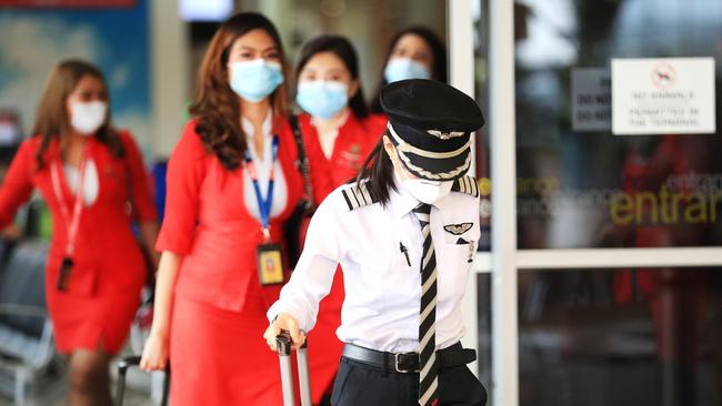 Air Asia flight crew arrive at Gold Coast Airport. Picture: Scott Powick.