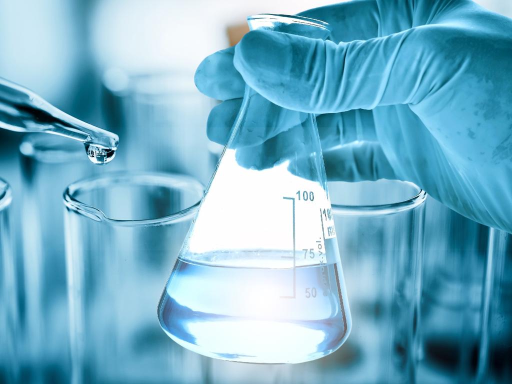 hand of scientist holding flask with lab glassware in chemical laboratory background, science laboratory research and development concept istock image