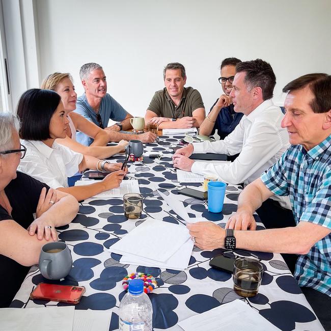 Chris Minns, second from right, and his leadership group get to work in his Kogarah dining room on Sunday morning.