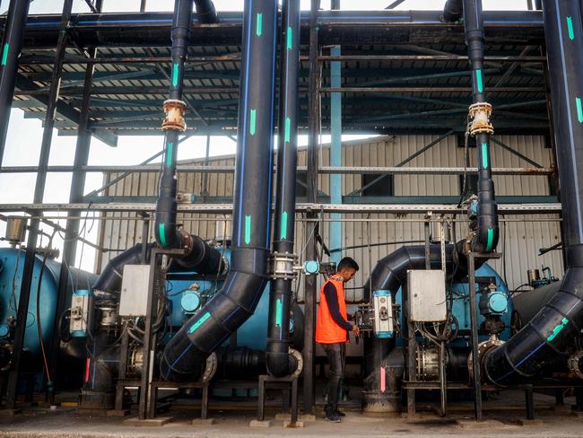 A worker turns a valve at the Southern Gaza Desalination plant, which stopped working earlier after Israel cut off electricity supply to the Gaza Strip. Picture: AFP