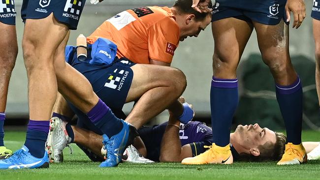 MELBOURNE, AUSTRALIA - APRIL 16: Ryan Papenhuyzen of the Storm is attended to by a team trainer after a tackle during the round six NRL match between the Melbourne Storm and the Sydney Roosters at AAMI Park on April 16, 2021, in Melbourne, Australia. (Photo by Quinn Rooney/Getty Images)