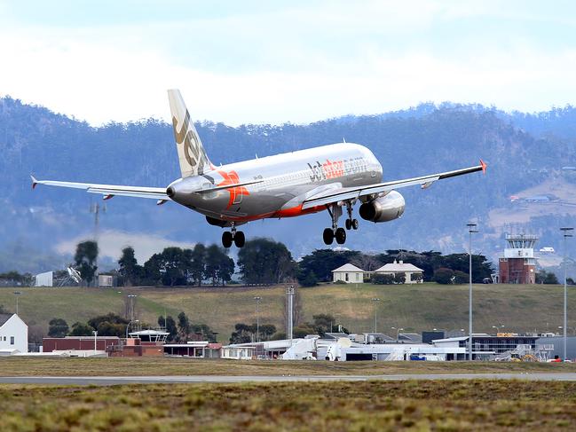 SUNTAS: Generic shots of planes taking off or coming into land, at Hobart Airport. a Jetstar plane landing