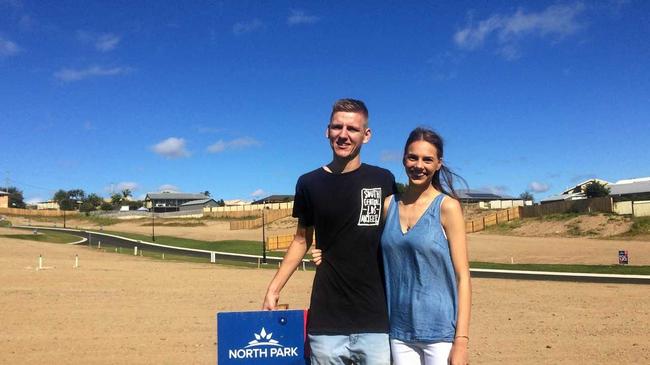 EXCITING TIMES: Bryce Roy and Rhiannon Tedge out the front of their new North Park Estate property, expected to be built by Christmas. Picture: Josh Preston