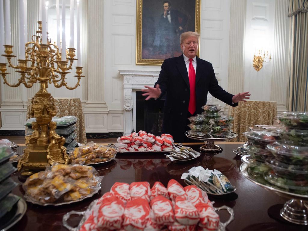 US President Donald Trump speaks alongside fast food he purchased for a ceremony honoring the 2018 College Football Playoff National Champion Clemson Tigers in the State Dining Room of the White House in Washington, DC. Trump says the White House chefs are furloughed due to the partial government shutdown. Picture: AFP