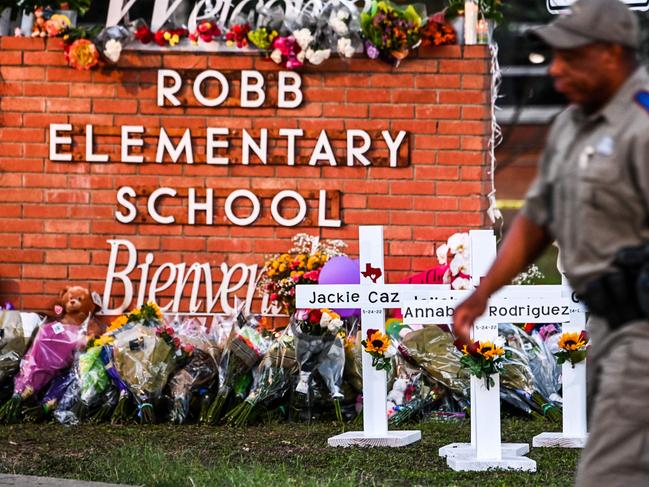 Officers stand near a memorial at Robb Elementary School following a mass shooting on in Uvalde, Texas. Picture: AFP.