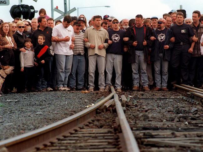 MUA dock workers link arms to block cargo trains in after the mass sacking of wharfies by Patrick Stevedores.