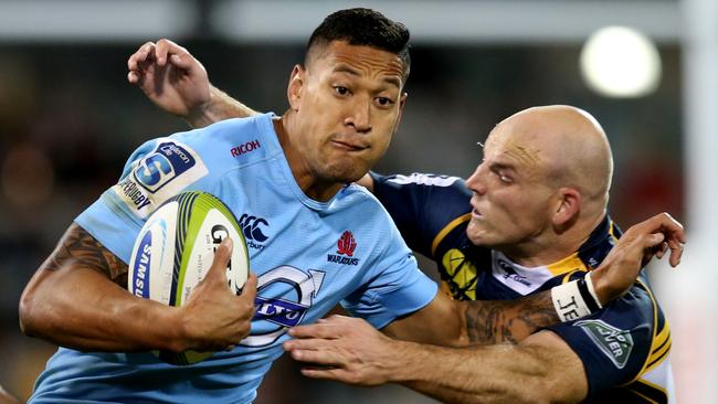 Brumbies vs Waratahs at GIO Stadium in Canberra. Brumbies Stephen Moore tackles Waratahs Israel Folau. Pic By Kym Smith