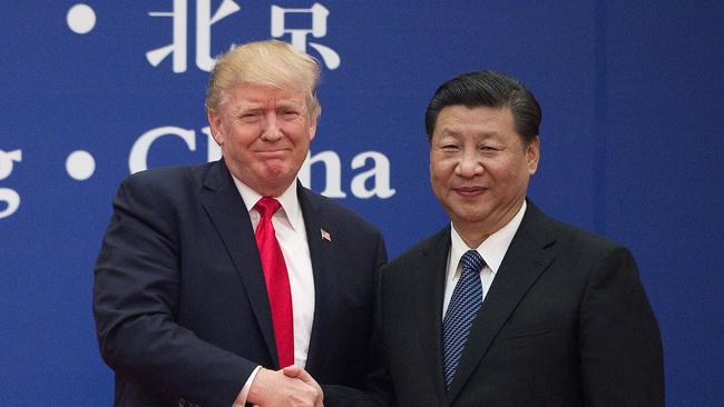 US President Donald Trump and China's President Xi Jinping shaking hands during a business leaders event at the Great Hall of the People in Beijing, November 2017. Picture: Nicolas Asfouri/AFP