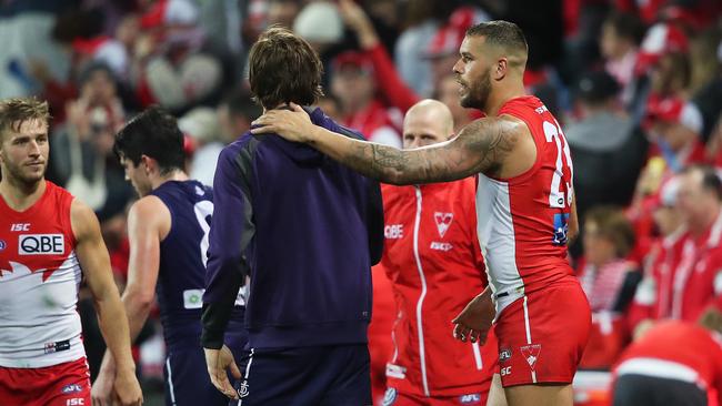 Sydney's Lance Franklin checks on Joel Hamling after the game. Picture. Phil Hillyard