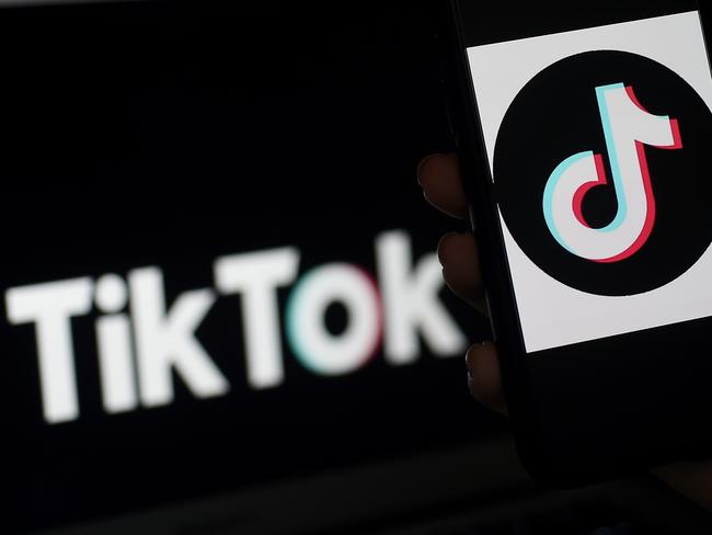 (FILES) In this file illustration photo taken on April 13, 2020 the social media application logo of TikTok is displayed on the screen of an iPhone in Arlington, Virginia - TikTok, the social media platform that is all the rage with the world's teens, could break away from its Chinese parent to evade a US ban, a top White House adviser said on July 16, 2020. "We haven't made final decisions (on the ban) but as has been reported in some places, I think TikTok is going to pull out of the holding company which is China-run and operate as independent company," White House economic advisor Larry Kudlow told reporters. (Photo by Olivier DOULIERY / AFP)