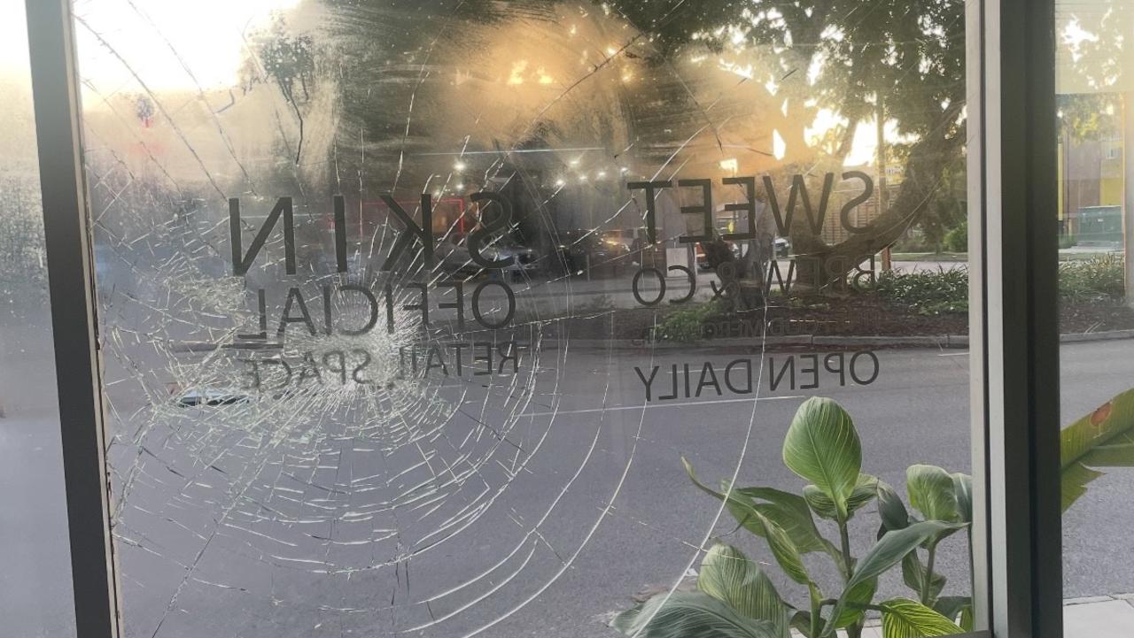 The front window of the cafe has been smashed and graffitied multiple times since the bus stop was planted. Picture: Harry Brill.