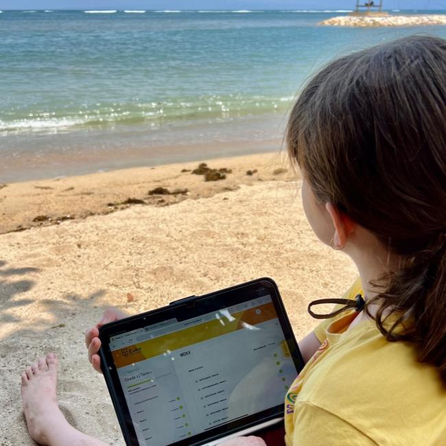 Seven-year-old Lola Dickson does her Year 2 schoolwork from the beach sometimes. Photo: Supplied.