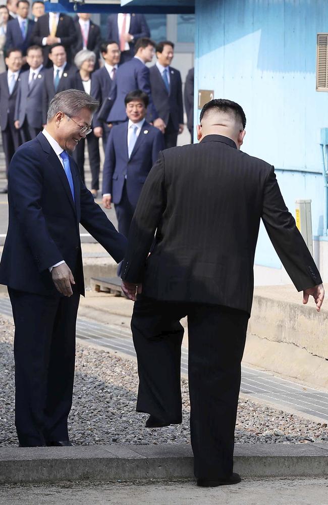 North Korean leader Kim Jong Un crosses the military demarcation line to meet with South Korean President Moon Jae-in from the back. Picture: AP