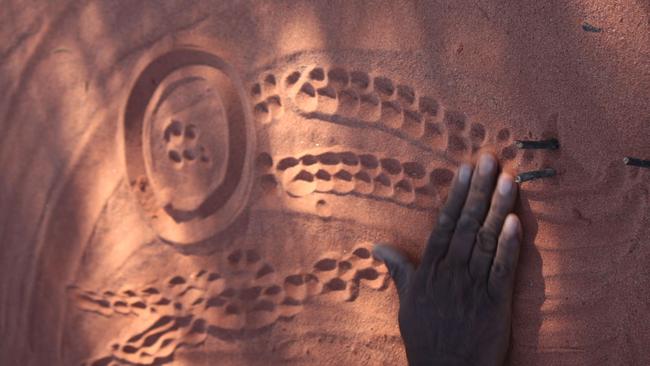 Sand picture by KW, describing the story of the evil sister. KW used traditional sand drawings to dispel breast cancer myths in remote communities.