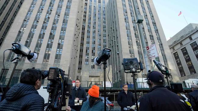 Media gathered outside the Manhattan Criminal Court in New York City on April 22, 2024. (Photo by TIMOTHY A. CLARY / AFP)